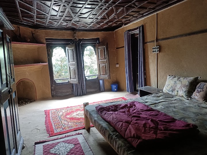 Traditional Kumaoni bedroom interior with wooden ceiling and large windows