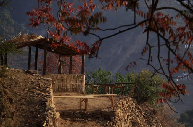 Rustic wooden gazebo on a hillside viewing area at Daankudi