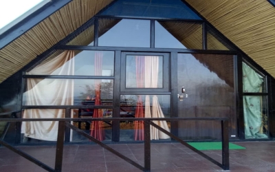 Spacious Family Cottage front with large glass wall and private deck