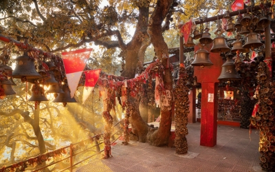 Exterior of a temple covered in thousands of bells hanging by devotees