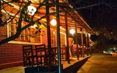 Outdoor covered dining area illuminated at night